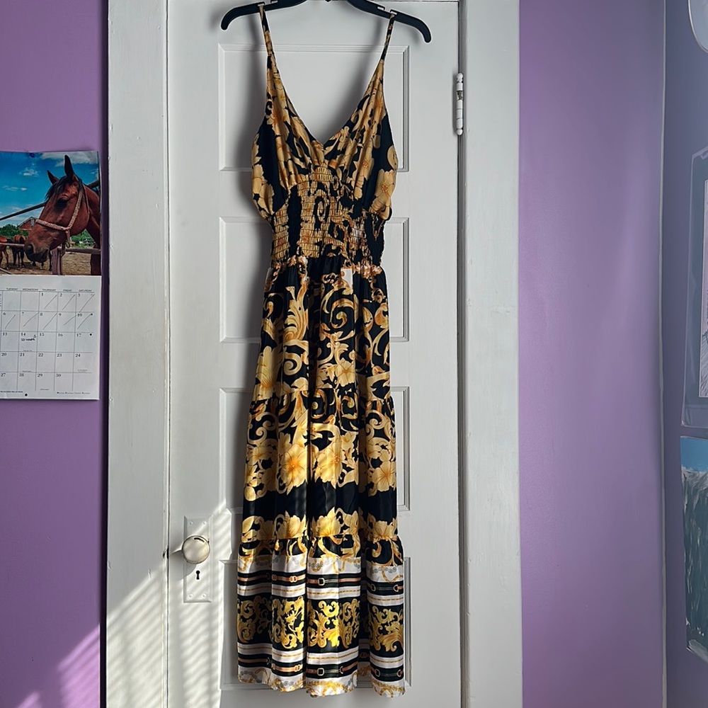We have a black white and gold yellow dress